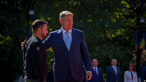 Romanian President Klaus Iohannis greets Ukraine's President Volodymyr Zelenskyy, left, at the Cotroceni Presidential Palace in Bucharest, Romania, Oct. 10, 2023. 
