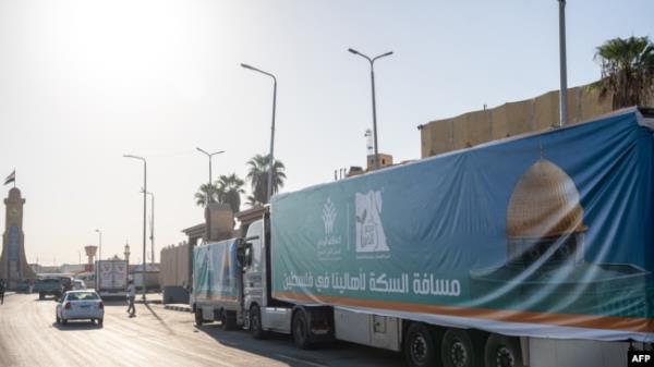 A co<em></em>nvoy of trucks loaded with aid supplies for Gaza provided by Egyptian NGOs waits for an agreement to cross through the Egypt-Gaza border in Arish City in Egypt’s north Sinai Peninsula on Oct. 15, 2023.