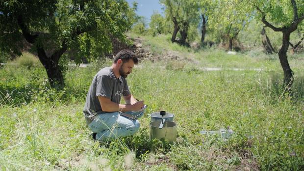 Farmer Miguel ángel Gómez checks the water infiltration capacity of the soil on his farm. 