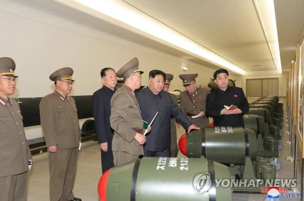 This file photo, carried by North Korea's official Korean Central News Agency on March 28, 2023, shows North Korean leader Kim Jong-un (4th from R) guiding the country's nuclear weapo<em></em>nization project the previous day, while calling for expanding the production of weapons-grade nuclear materials. (For Use o<em></em>nly in the Republic of Korea. No Redistribution) (Yonhap)