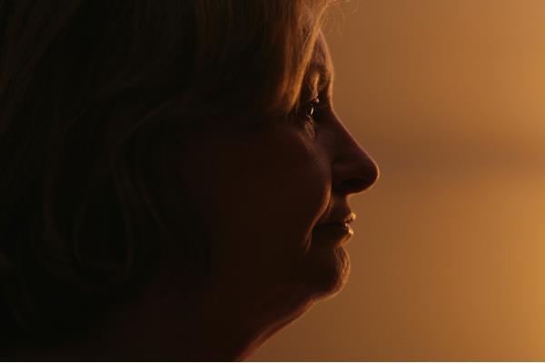Depressed mature woman sitting on the floor at home