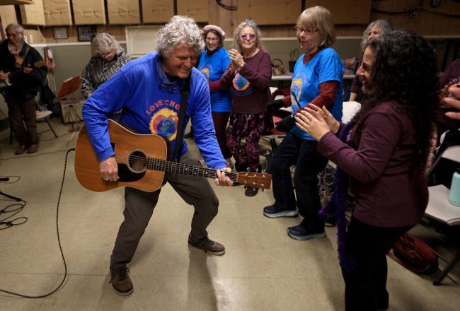 Jim Corbett belts out a song as Love Choir participants join in at the Sebastopol Grange Hall, Monday, March 27, 2023.  (Kent Porter / The Press Democrat file)