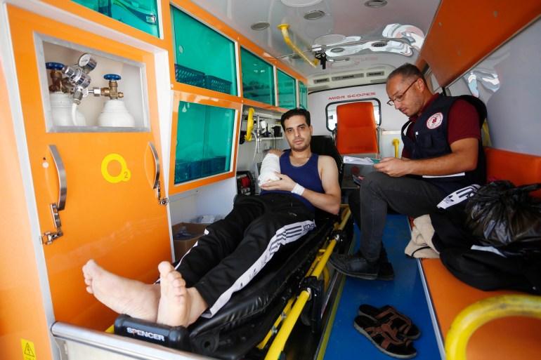 Khader Shamout, a paramedic volunteer, was wounded in an Israeli air attack while transporting other wounded Palestinians in am ambulance in the southern city of Khan Younis