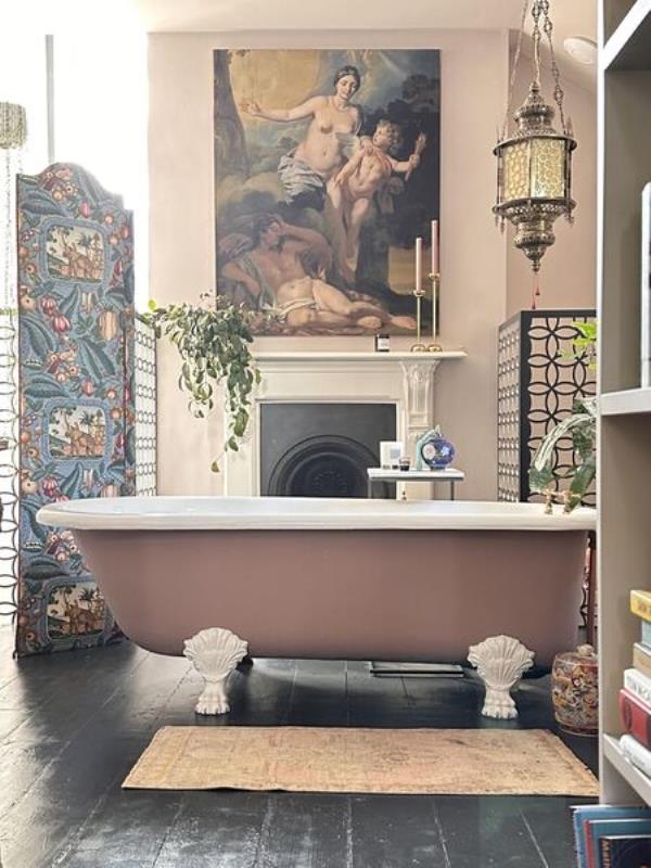  The boudoir-style bathroom is hidden behind a bookcase door on the return of the stairs.