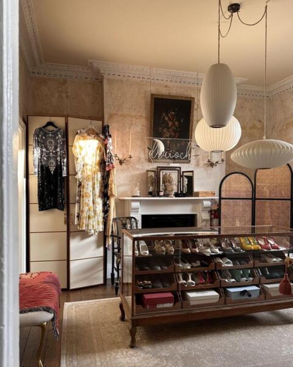  Modern cupboards and a vintage shop display unit provide an eclectic mix of storage in Mona's dressing room.