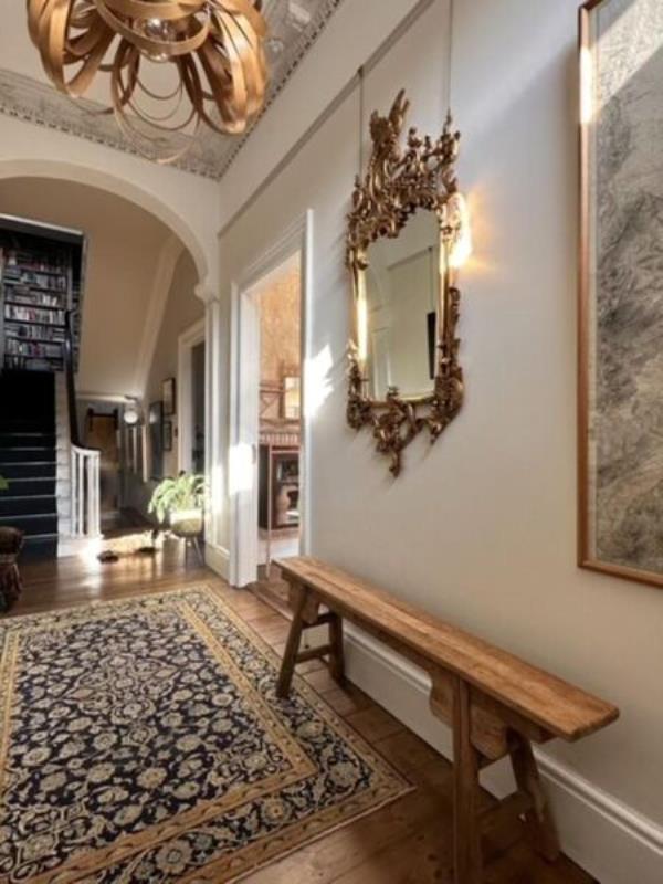  An inviting hallway leads to the repurposed reception rooms.
