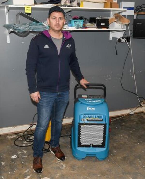  Damian O'Brien of Fox & Co Menswear during the clean-up operation of his premises as a result of the flooding in Midleton Co Cork. Picture: David Keane.