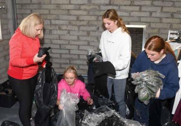  Laragh O'Brien of Flamingo Clothing, sorting damaged goods with Alison Keating, Charlotte O'Brien and Kalyn Manning, as a result of the flooding in Midleton Co Cork. Picture: David Keane.