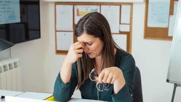 Young Tired Female Professor Havin<em></em>g Headache