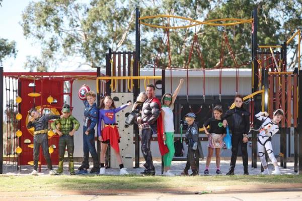Flynn James, 9, Noah Tipene, 9, Liam Dunstan, 11, Maddie Duggan, 11, Phoebe Madden, 3, Dave Madden, (Hunter's father), Kate Bettenay (Hunter's mother), Zac Madden 8, Evie Abbot, 8, Hannah Vincent, 11, and Layken Collins, 9. Hillcrest Primary School students dressed as their favourite hero in support of childhood cancer families for Hero Hunter Day. The day celebrates the courage of kids fighting cancer and ho<em></em>nours the life of Hunter Madden, a student at Hillcrest Primary, who heroically fought leukaemia for five years. Hunter sadly died at eight years old in 2021. Danella Bevis