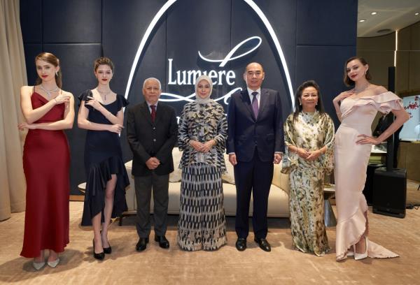 (From third left) Raja Aman, Tengku Permaisuri Norashikin, Ng and No<em></em>nadiah with the fashion models at the event.