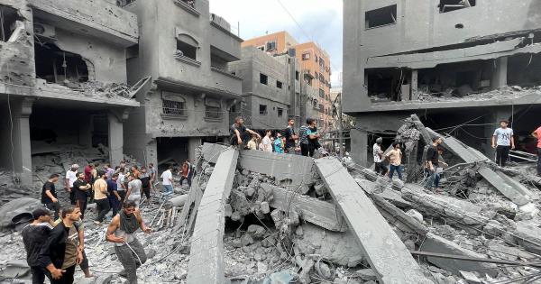 Palestinians look for survivors after an Israeli airstrike on buildings at Shati refugee camp, Gaza Strip, Friday, Oct. 27, 2023. (AP Photo/Mohammed Al Masri)