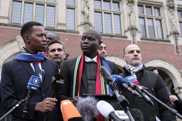 South Africa's Minister of Justice and Correctio<em></em>nal Services Ro<em></em>nald Lamola, center, and Palestinian assistant Minister of Multilateral Affairs Ammar Hijazi, right, address the media outside the Internatio<em></em>nal Court of Justice in The Hague, Netherlands, Thursday (Picture: AP Photo/Patrick Post)