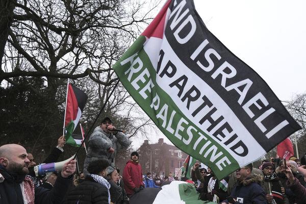 Protestors wave Palestinian flags during a demo<em></em>nstration march outside the Internatio<em></em>nal Court of Justice in The Hague, Netherlands, Thursday. Picture: AP Photo/Patrick Post