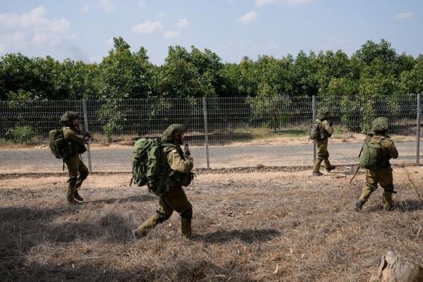 CORRECTS DAY TO SATURDAY - Israeli soldiers deploy in kibbutz Kfar Azza on Tuesday, Oct. 10, 2023. Hamas militants overran Kfar Azza on Saturday, wher<em></em>e many Israelis were killed and taken captive. (AP Photo/Ohad Zwigenberg)
